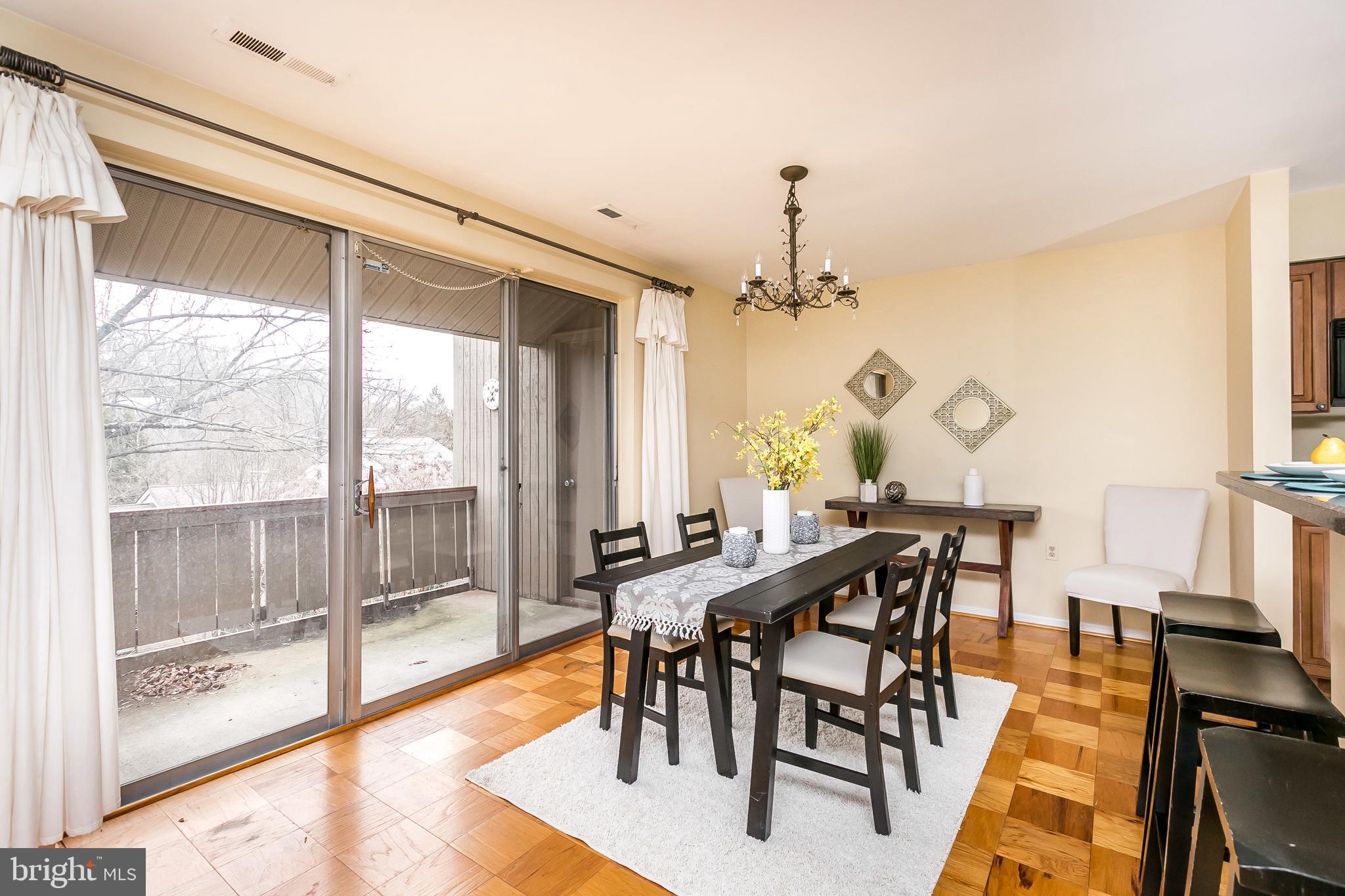 114 Cross Keys Road, Unit R114E Baltimore, MD 21210 - Photo 9 of 33 a view of a dining room with furniture window and wooden floor
