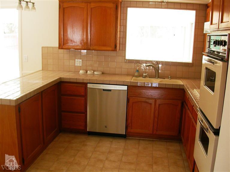 7248 Arthur Rondo Ventura, CA 93003 - Photo 8 of 28 a kitchen with stainless steel appliances granite countertop a sink stove and refrigerator