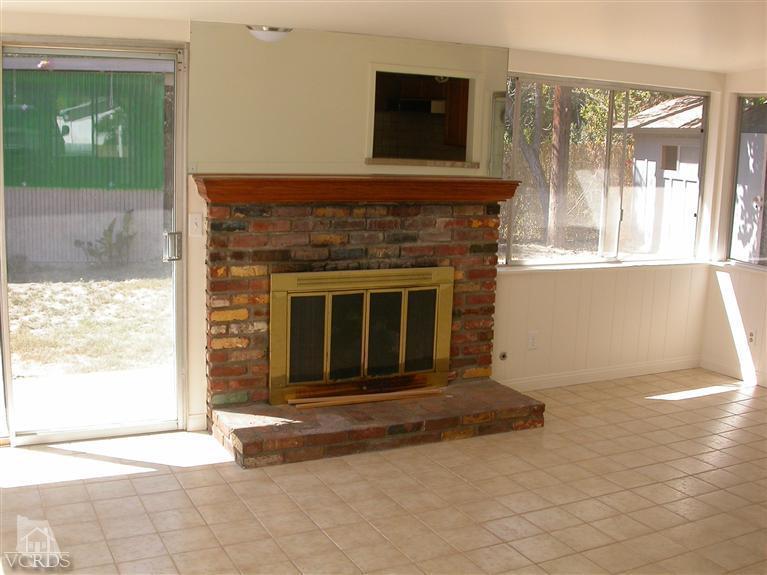 7248 Arthur Rondo Ventura, CA 93003 - Photo 10 of 28 a living room with a fireplace and a large window