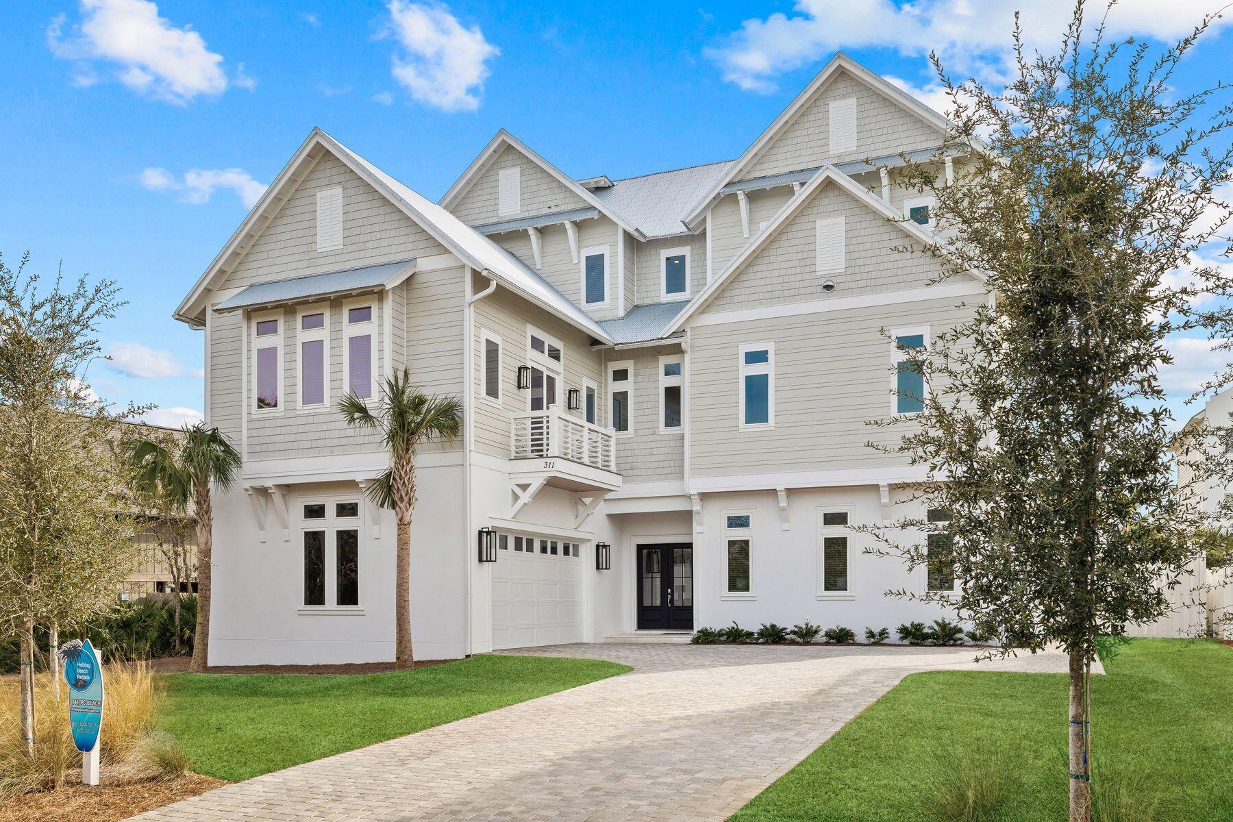 311 Walton Rose Ln Inlet Beach Inlet Beach, FL 32461 - Photo 4 of 93 a front view of a house with a yard and trees