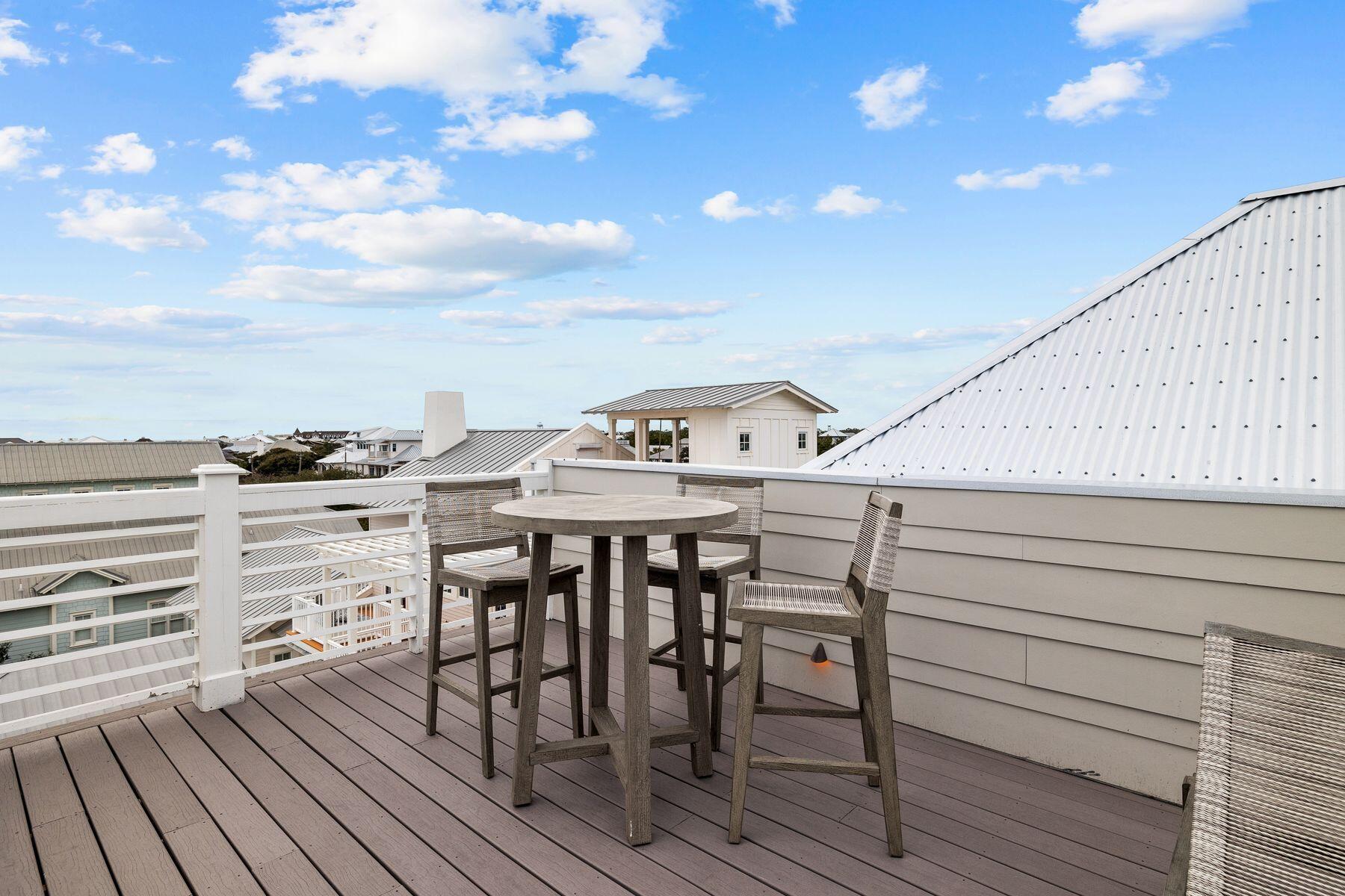 311 Walton Rose Ln Inlet Beach Inlet Beach, FL 32461 - Photo 84 of 93 a view of a roof deck with table and chairs with wooden floor