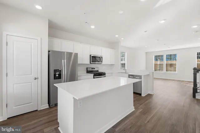 a kitchen with stainless steel appliances a refrigerator stove microwave and sink