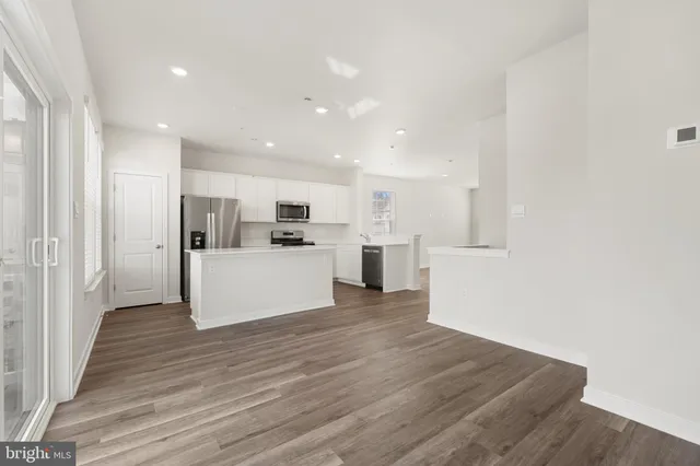 a view of a kitchen with wooden floor