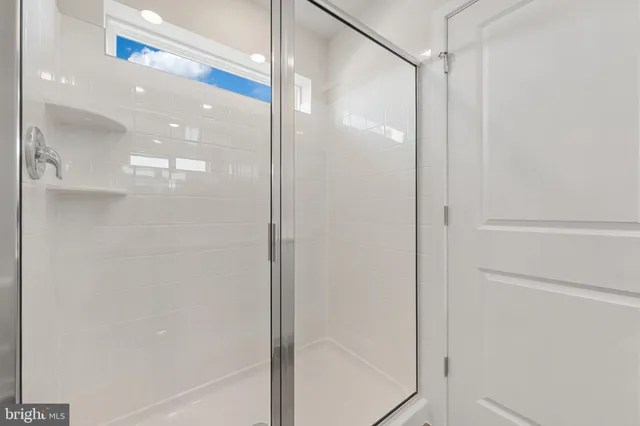 a view of an empty walk in closet with wooden floor