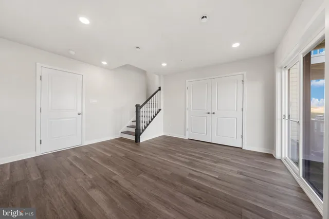 a bathroom with a toilet a sink a mirror a bathtub and vanity
