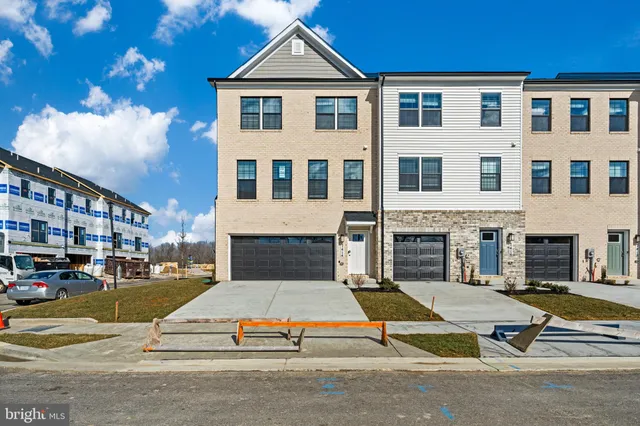 a front view of a building with a garden