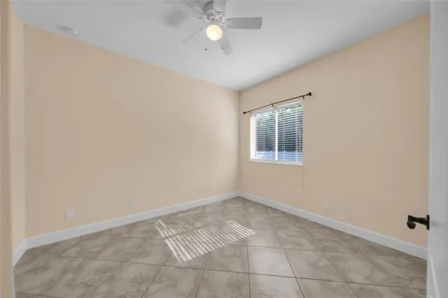 a bathroom with a granite countertop bathtub shower and toilet