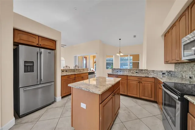 a view of a dining room with furniture and a chandelier fan
