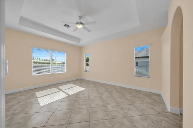 a spacious bathroom with a granite countertop sink a toilet and a bathtub