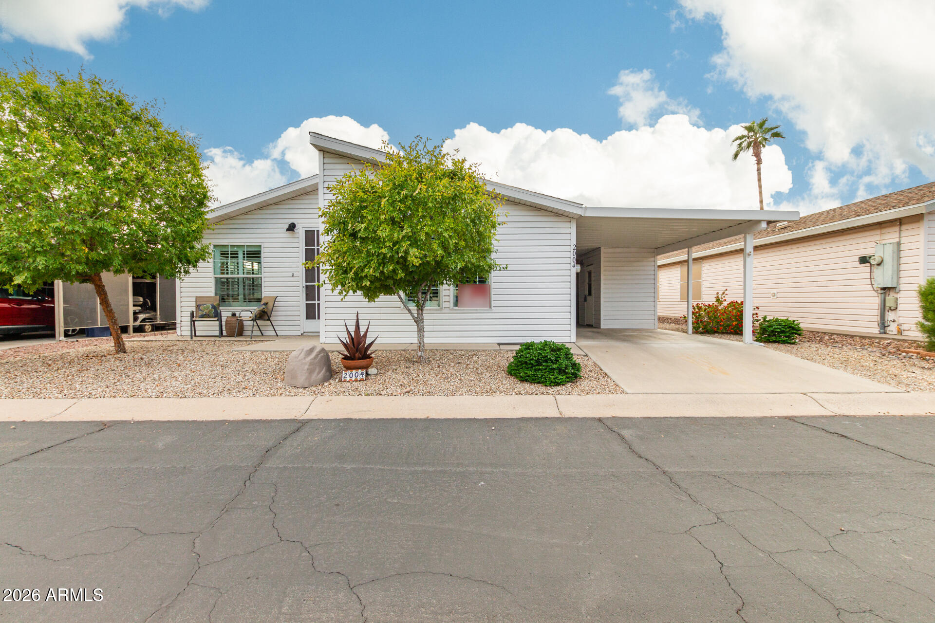 3301 South Goldfield Road, Unit 2004 Apache Junction, AZ 85119 - Photo 12 of 40 a view of a house with a yard and a garage