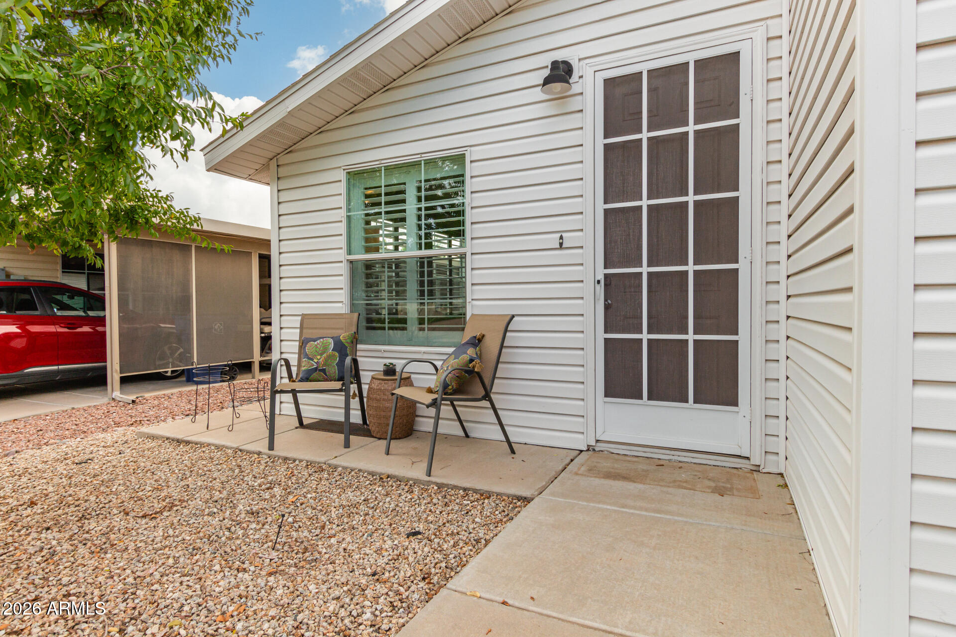 3301 South Goldfield Road, Unit 2004 Apache Junction, AZ 85119 - Photo 14 of 40 a backyard of a house with table and chairs