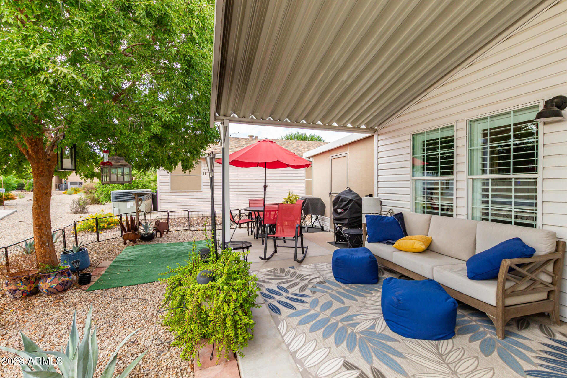 3301 South Goldfield Road, Unit 2004 Apache Junction, AZ 85119 - Photo 2 of 40 an outdoor living space with patio furniture and garden view