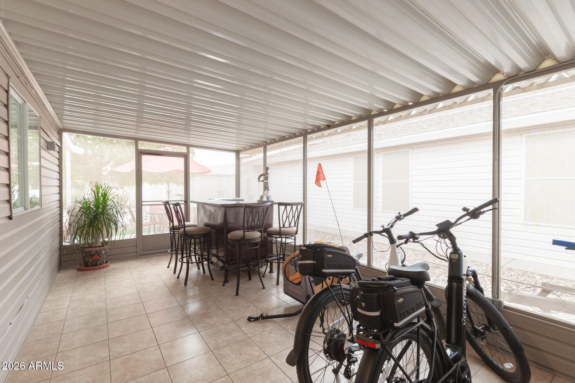3301 South Goldfield Road, Unit 2004 Apache Junction, AZ 85119 - Photo 25 of 40 a view of a patio with table and chairs