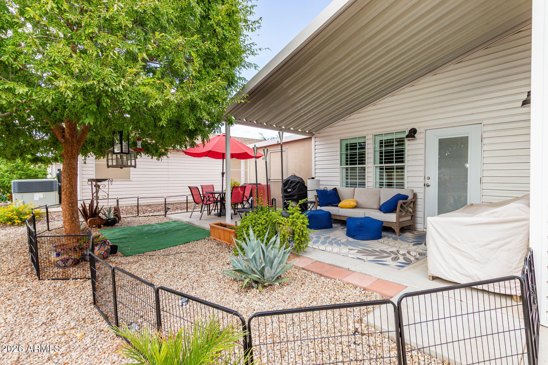 3301 South Goldfield Road, Unit 2004 Apache Junction, AZ 85119 - Photo 29 of 40 a view of a patio with couches table and chairs and potted plants