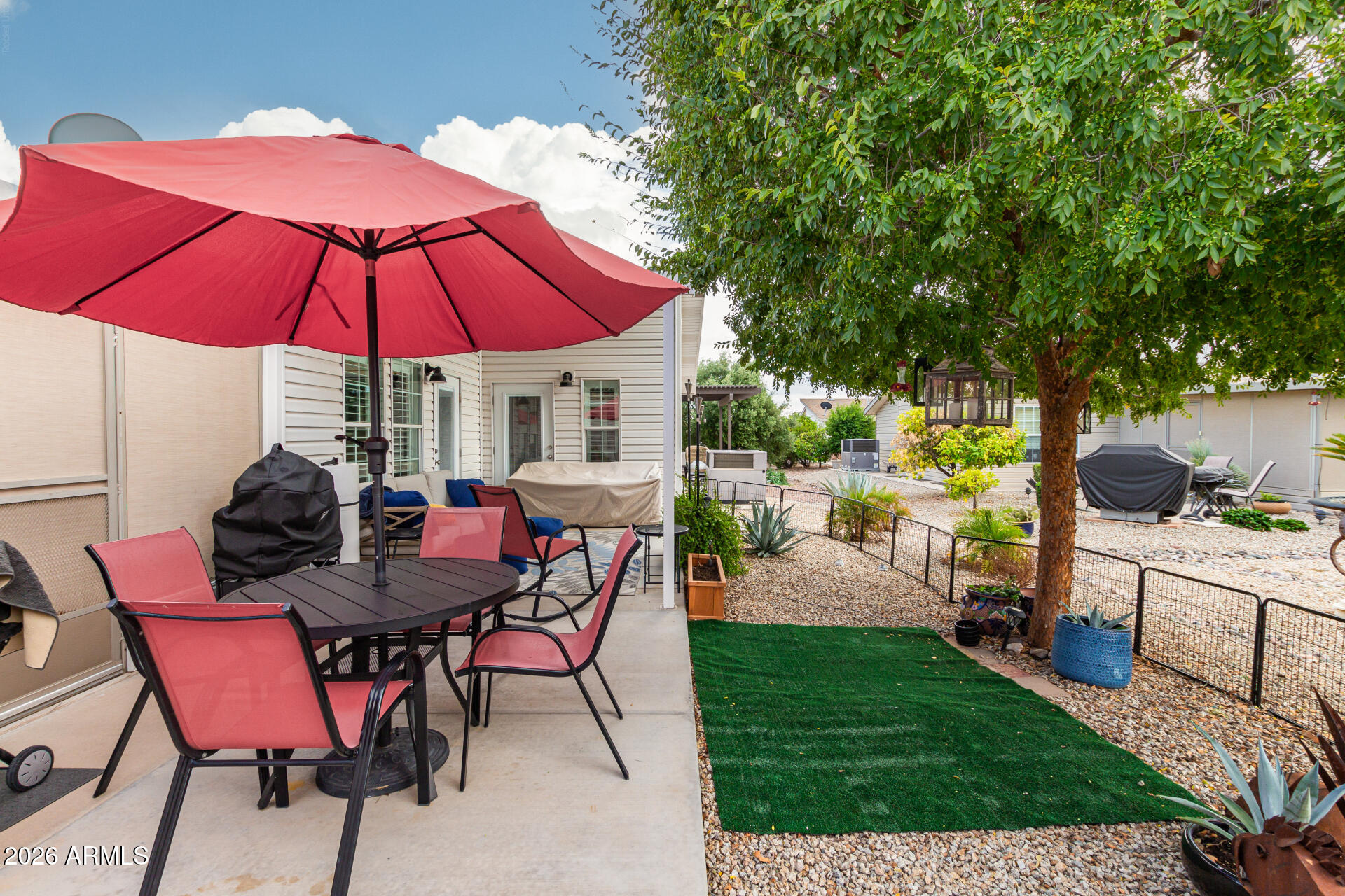 3301 South Goldfield Road, Unit 2004 Apache Junction, AZ 85119 - Photo 31 of 40 a view of a backyard with a patio and outdoor seating