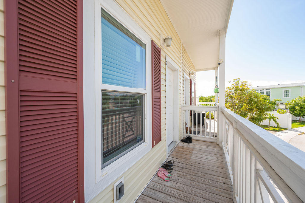 5030 5th Avenue, Unit 2 Key West, FL 33040 - Photo 2 of 16 a view of a balcony with wooden floor