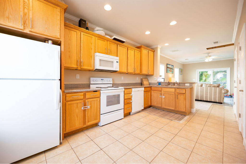 5030 5th Avenue, Unit 2 Key West, FL 33040 - Photo 3 of 16 a kitchen with stainless steel appliances a sink and a refrigerator