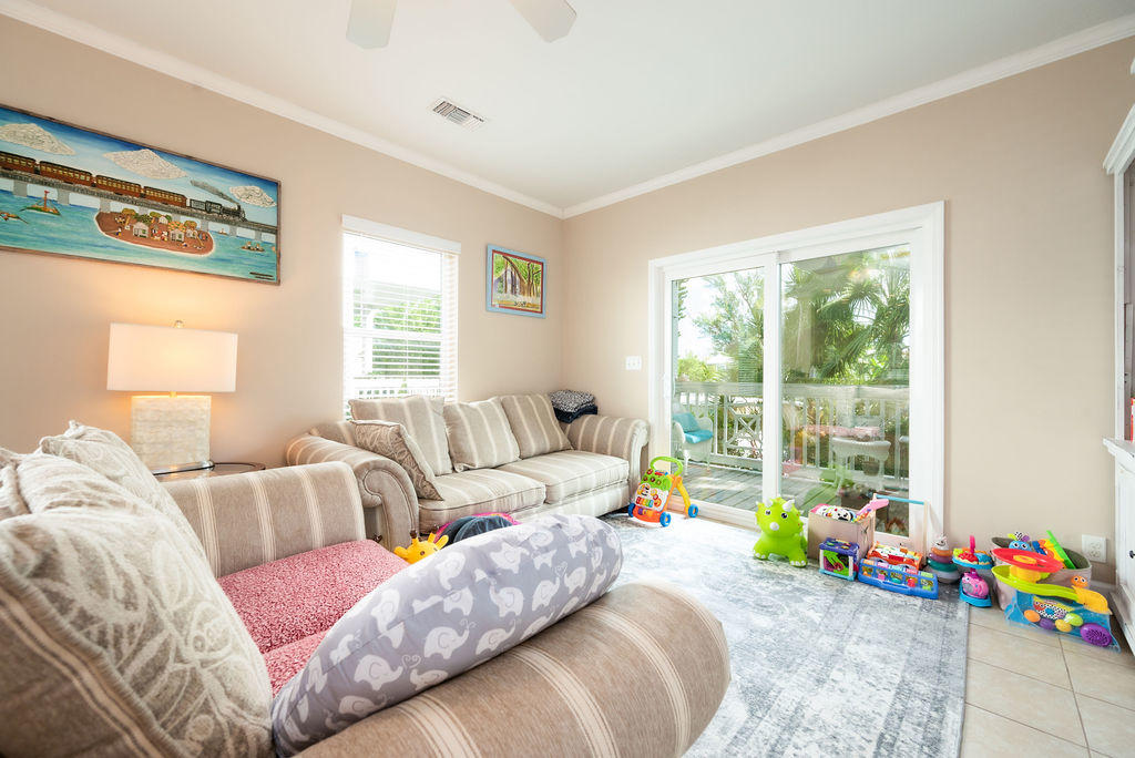 5030 5th Avenue, Unit 2 Key West, FL 33040 - Photo 4 of 16 a bedroom with furniture and a large window