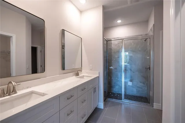 a bathroom with a granite countertop sink a toilet and bathtub