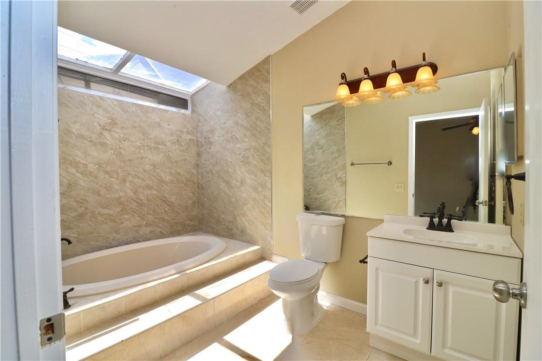 23237 Bentley Place Boca Raton, FL 33433 - Photo 8 of 16 a bathroom with a sink mirror toilet and bathtub
