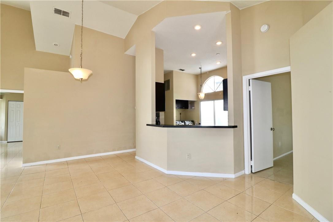 23237 Bentley Place Boca Raton, FL 33433 - Photo 9 of 16 a view of kitchen with stainless steel appliances granite countertop cabinets and front door