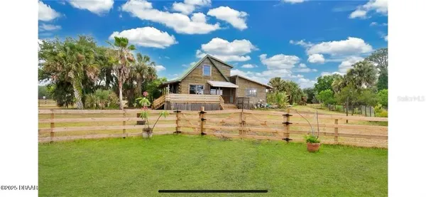 a view of house with a yard