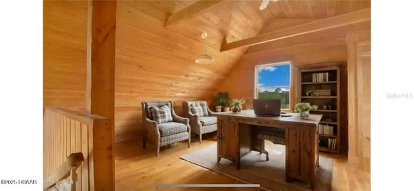 a living room with furniture a flat screen tv and a floor