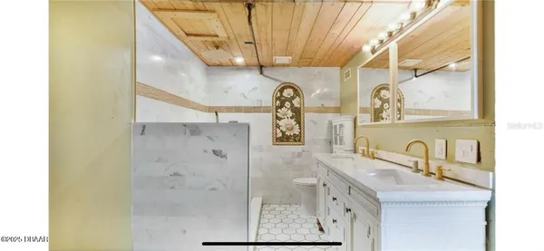 a bathroom with double vanity sink and a mirror