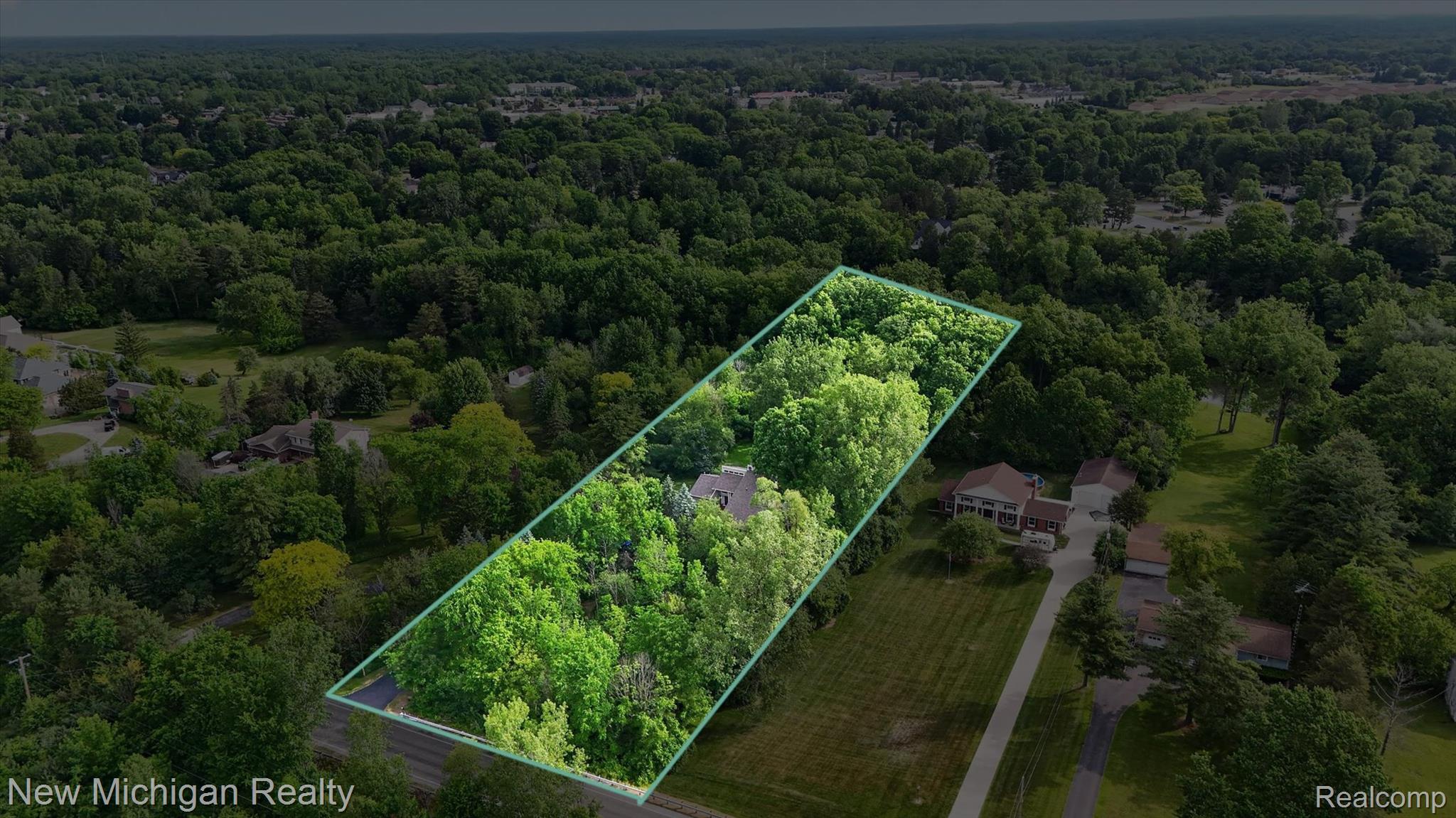 7156 East River Road Flushing, MI 48433 - Photo 4 of 35 Expansive wooded lot featuring mature trees and established greenery