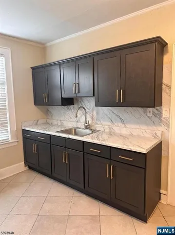 a bathroom with a granite countertop sink and vanity