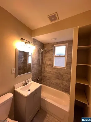 a bathroom with a sink a toilet and bathtub