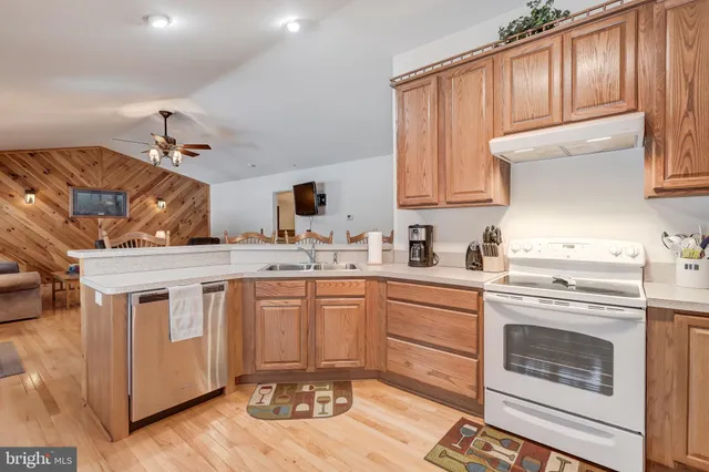 a kitchen with stainless steel appliances granite countertop a stove and white cabinets