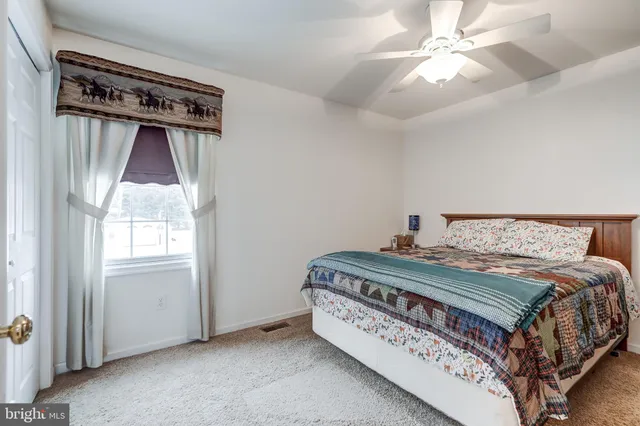 a bedroom with a bed next to a window