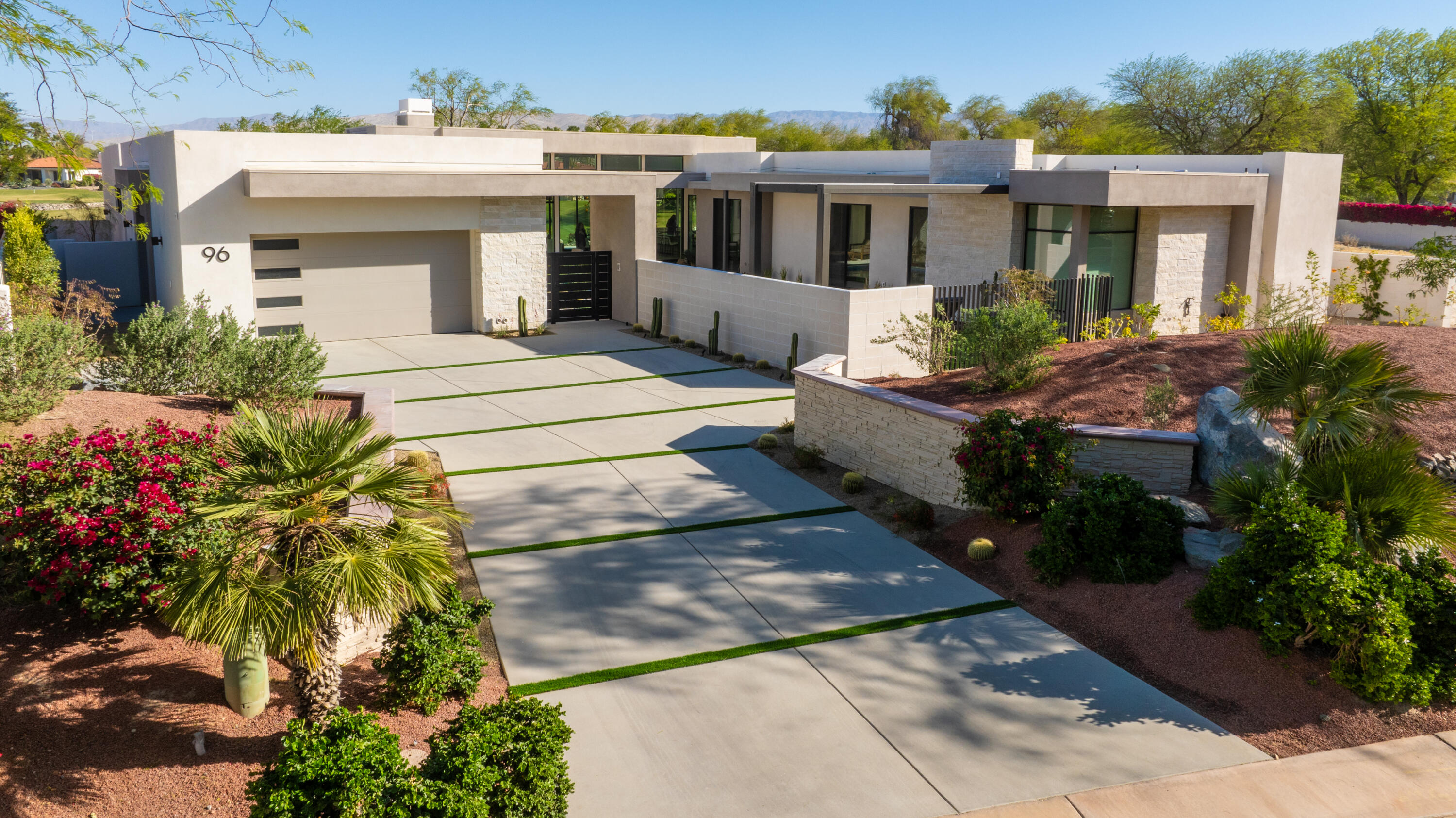96 Royal St Georges Way Rancho Mirage, CA 92270 - Photo 4 of 34 a front view of house with yard and trees around