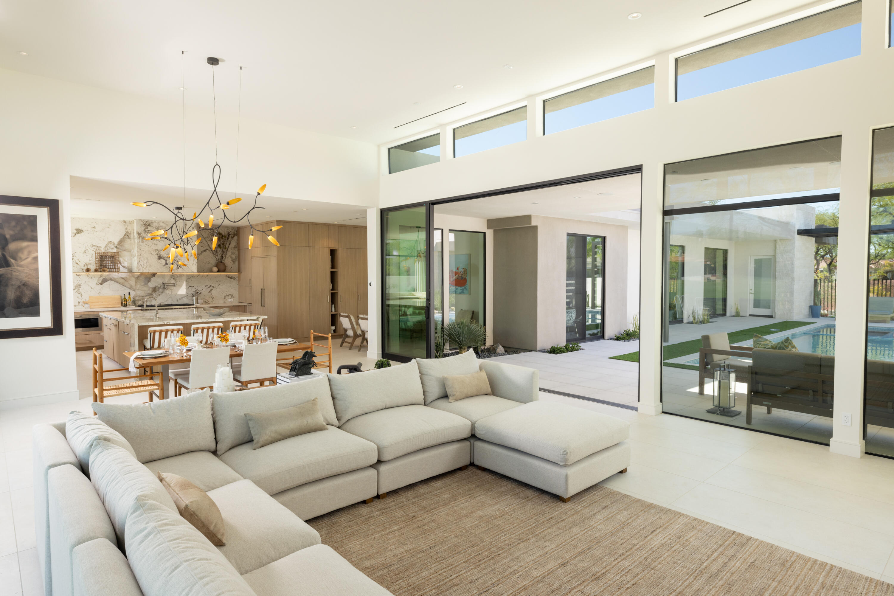 96 Royal St Georges Way Rancho Mirage, CA 92270 - Photo 10 of 34 a living room with furniture and a chandelier