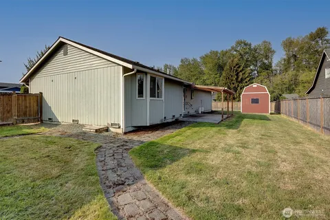 a front view of house with yard and garage