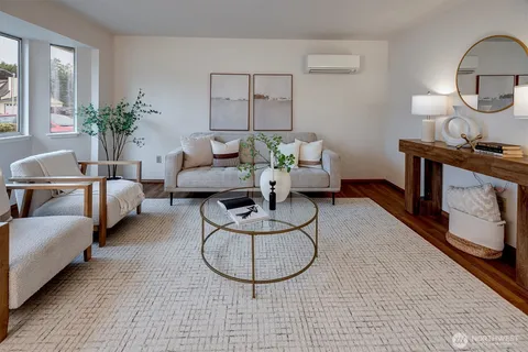 a living room with furniture a lamp and a potted plant