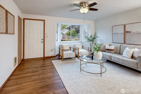 a living room with furniture and a chandelier