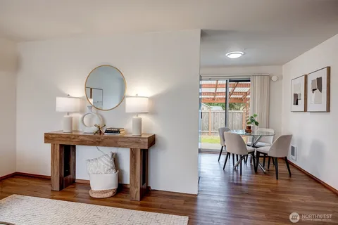 a view of a dining room with furniture window and wooden floor