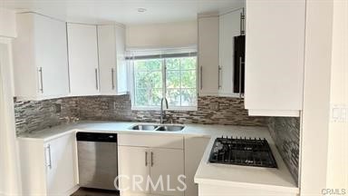 6846 St Estaban Street Tujunga, CA 91042 - Photo 12 of 13 a kitchen with white cabinets and a stove