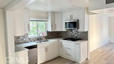6846 St Estaban Street Tujunga, CA 91042 - Photo 13 of 13 a kitchen with white cabinets and white appliances