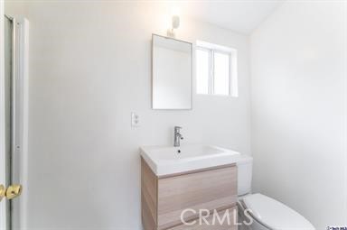 6846 St Estaban Street Tujunga, CA 91042 - Photo 7 of 13 a bathroom with a toilet a sink and mirror