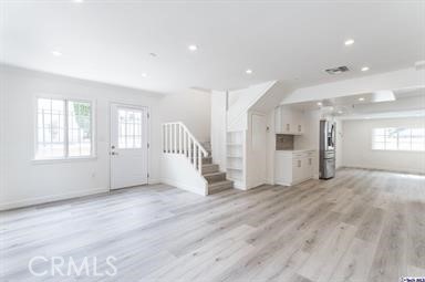 6846 St Estaban Street Tujunga, CA 91042 - Photo 8 of 13 an empty room with wooden floor and windows
