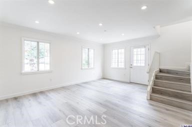 6846 St Estaban Street Tujunga, CA 91042 - Photo 9 of 13 an empty room with wooden floor and windows