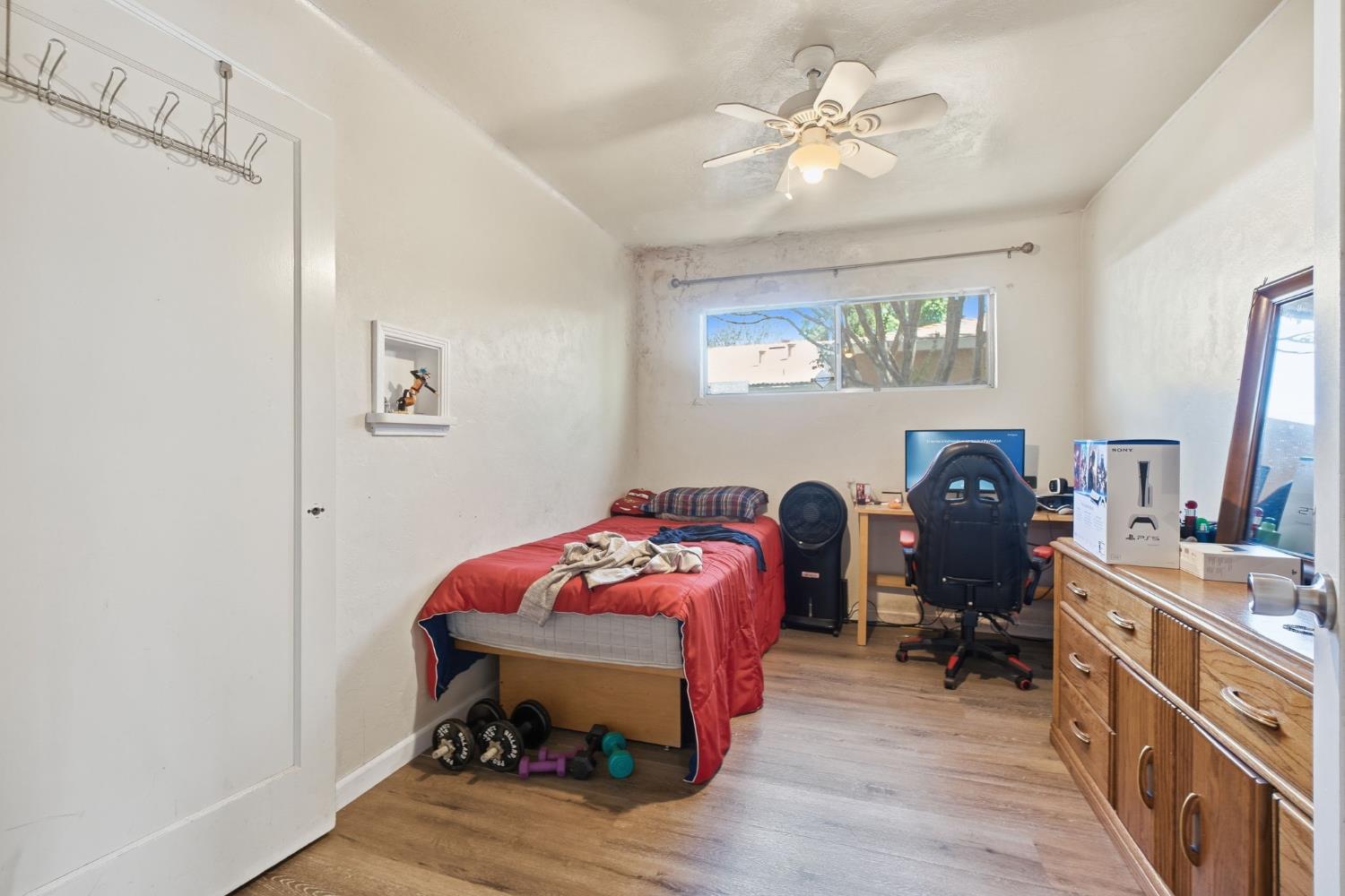 1705 Stetson Avenue Modesto, CA 95350 - Photo 11 of 32 a bedroom with furniture and a chandelier fan