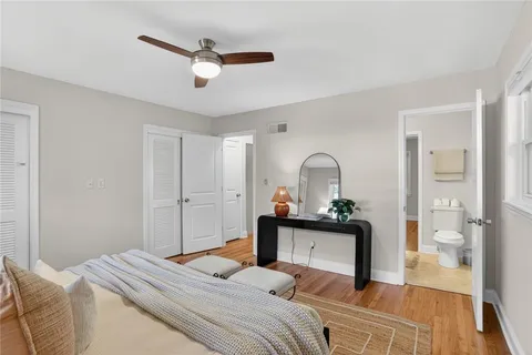 a bedroom with a bed and a large mirror