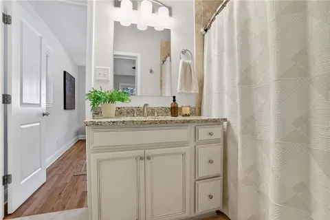 a bathroom with a granite countertop sink and a mirror