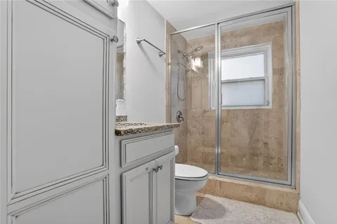 a bathroom with a shower toilet and sink