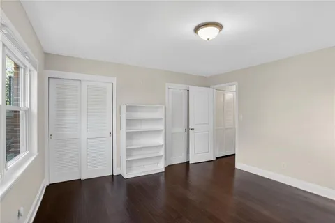 a view of a room with wooden floor