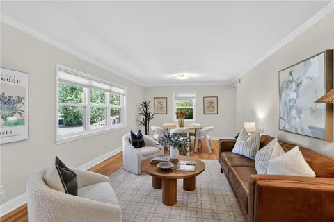 a living room with patio furniture and a large window